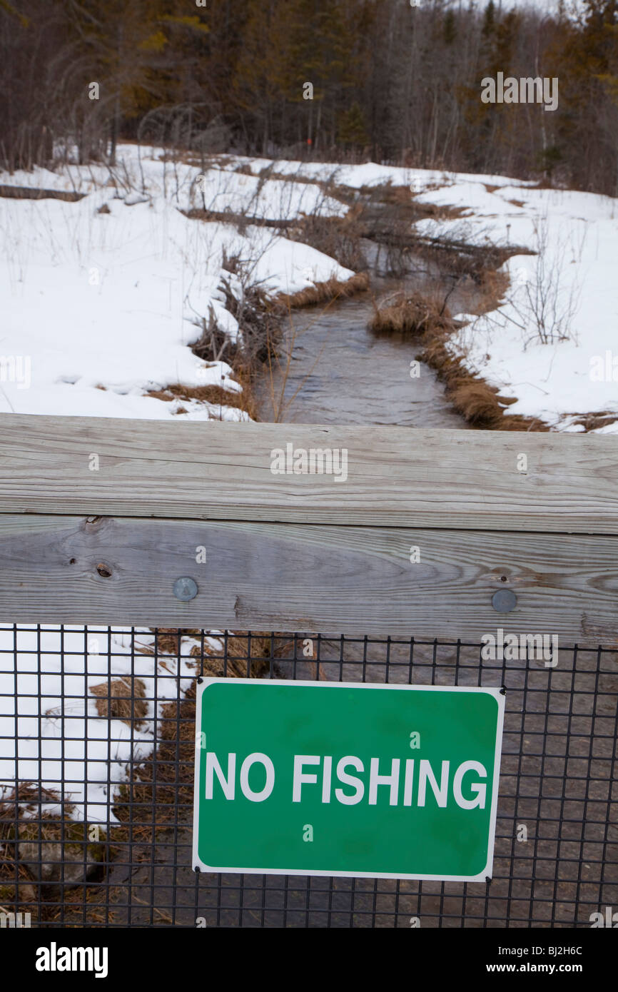 A sign prohibits fishing in a creek at the Oden State Fish Hatchery. Stock Photo