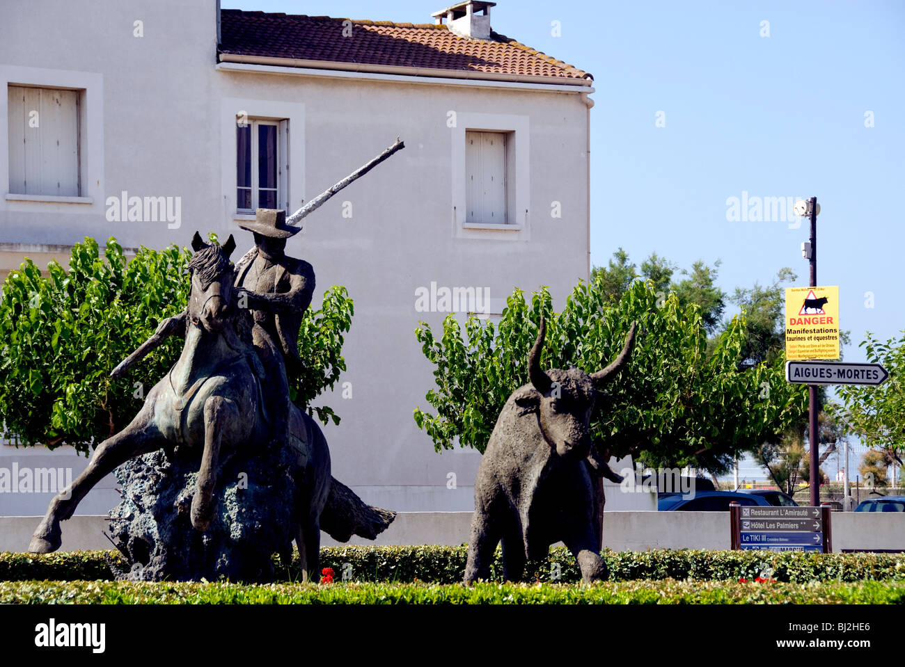 Statue of a gardian (cowboy) working the bull in Saintes Maries de la Mer, France Stock Photo