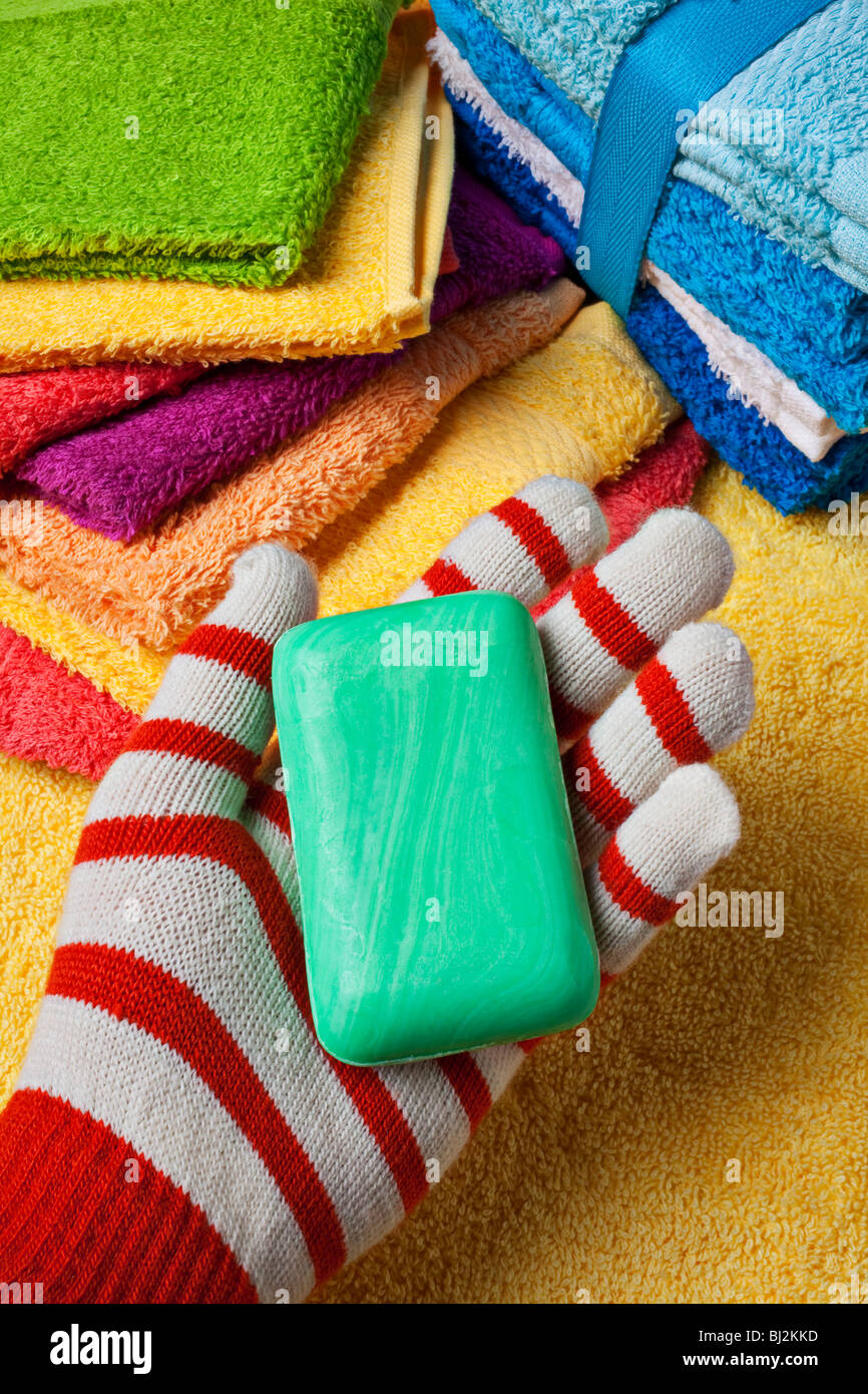 Stripped glove hand green bar soap towel wash clothes hires stock