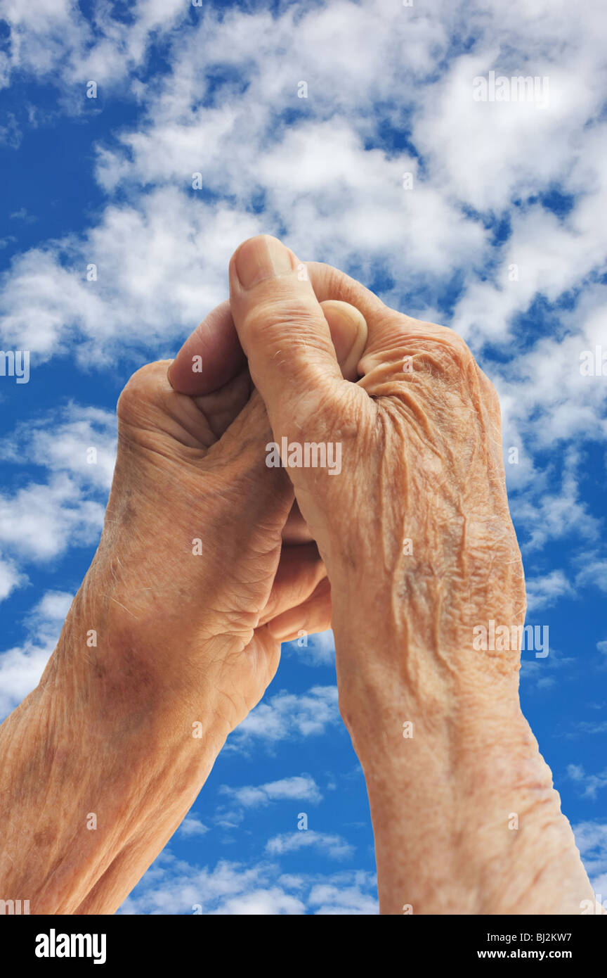 Senior woman's hands over sky Stock Photo