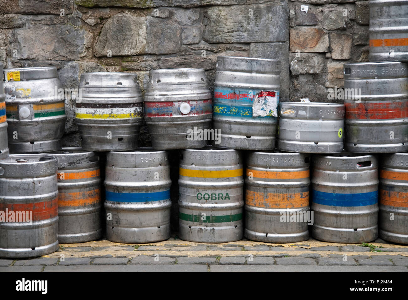Beer kegs stacked against a stone brick wall on North Thistle Street Lane, Edinburgh Stock Photo
