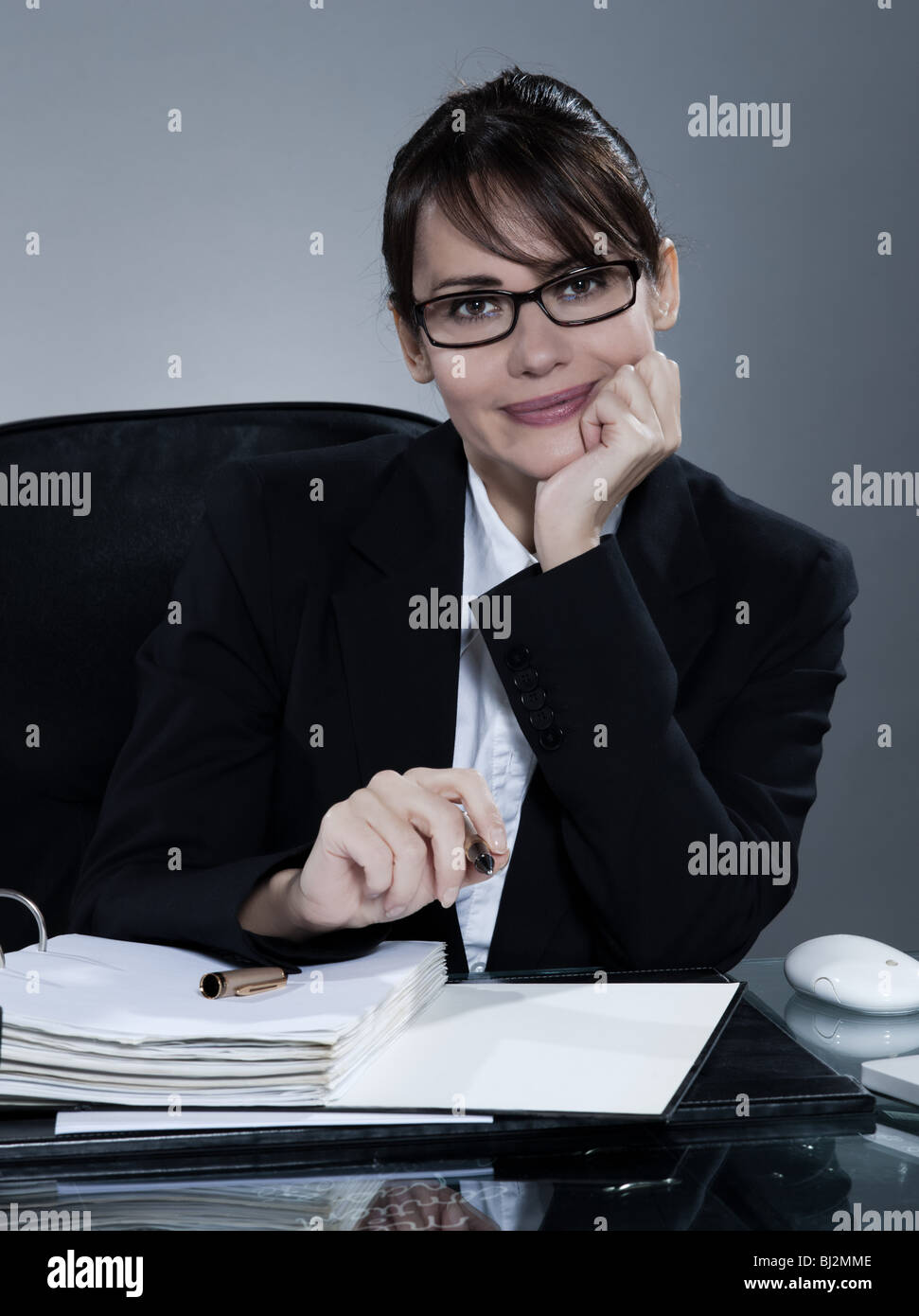 beautiful brunette business woman at her desk Stock Photo