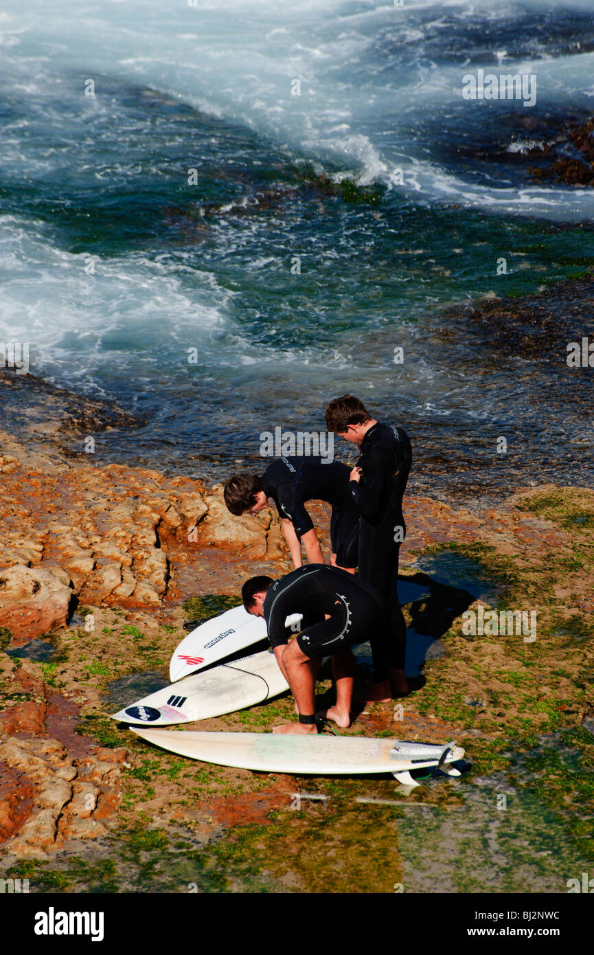 Surfers prepare to launch into the waves near Coogee beach, Sydney, Australia Stock Photo