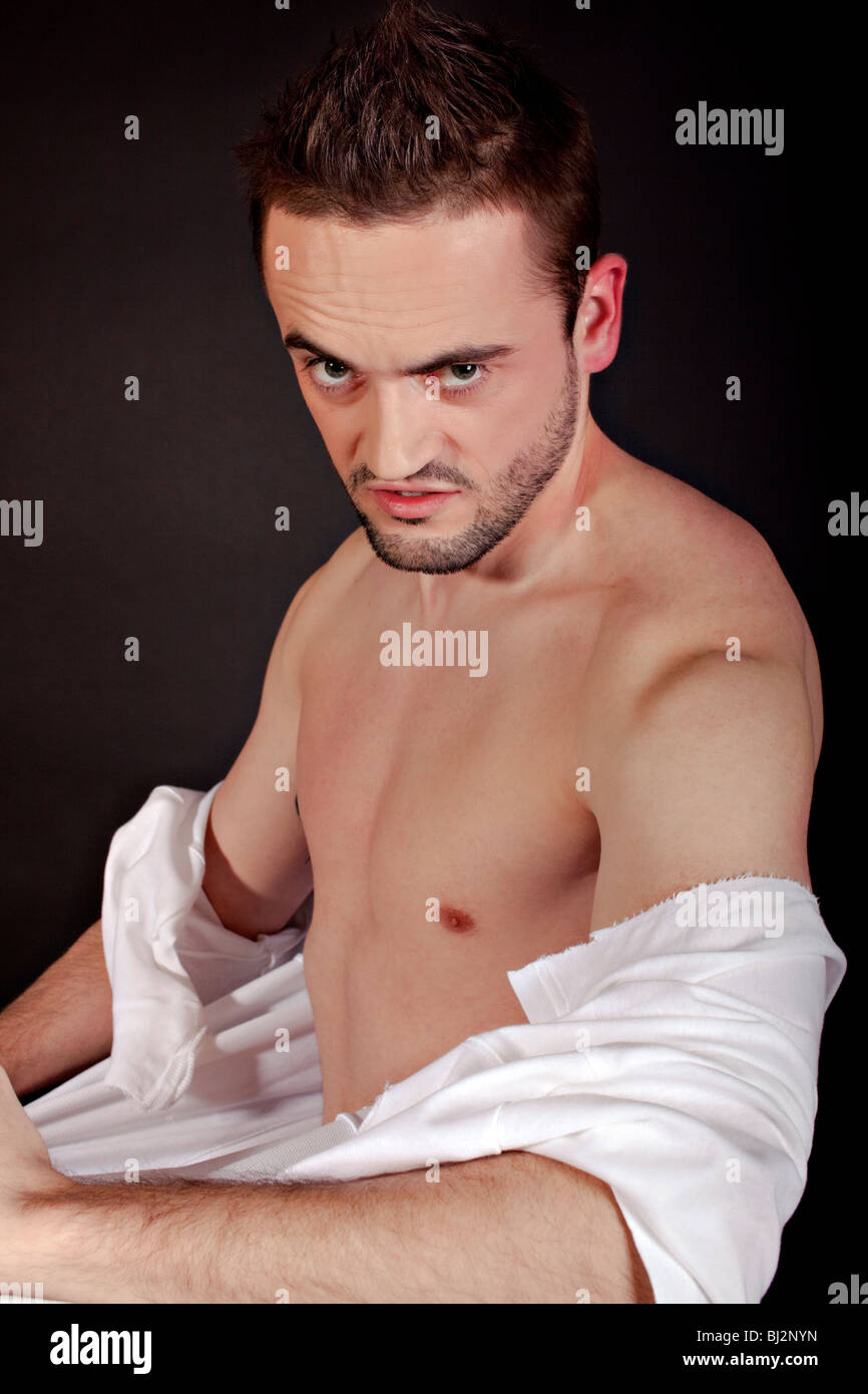 Angry man pull his tshirt Stock Photo Alamy