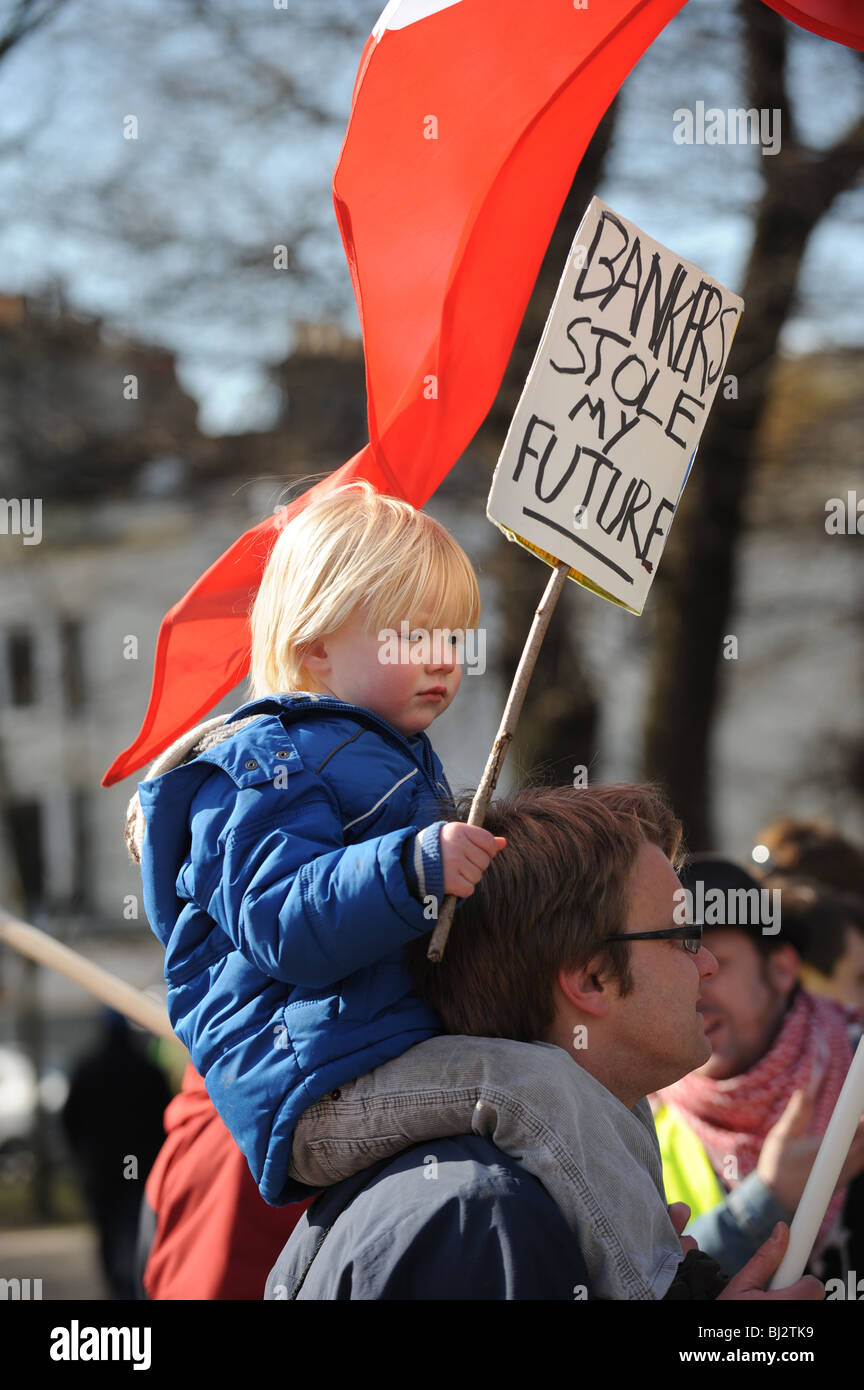 Young child with a placard protesting about bankers at a demonstration against job losses in Brighton UK Stock Photo