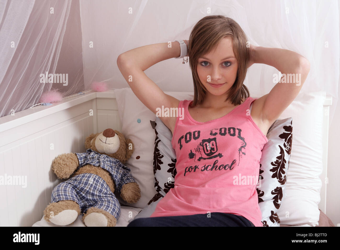 Portrait of a 14 year old girl lying on her bed Stock Photo Alamy