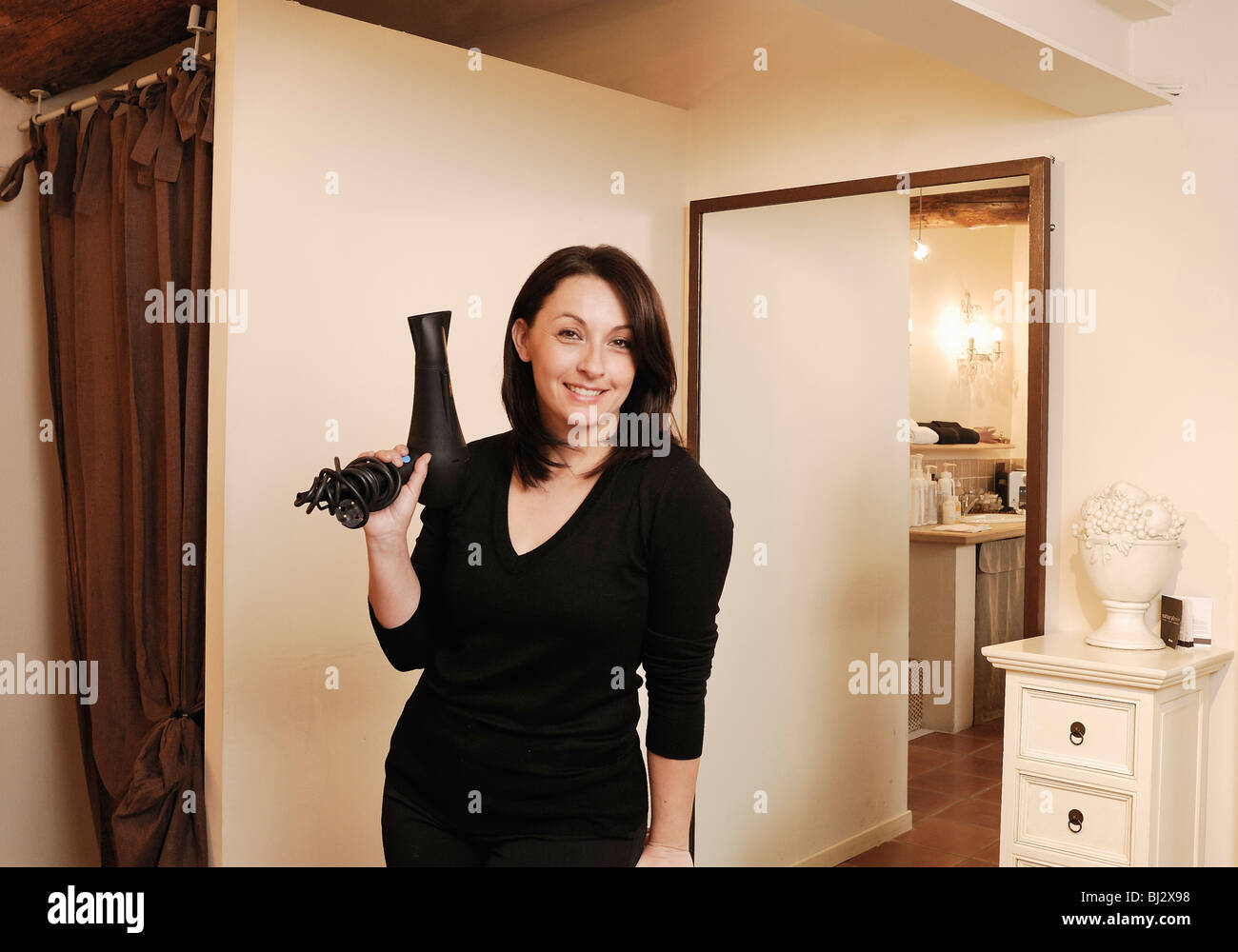 Portrait of a hairdresser in her salon Stock Photo