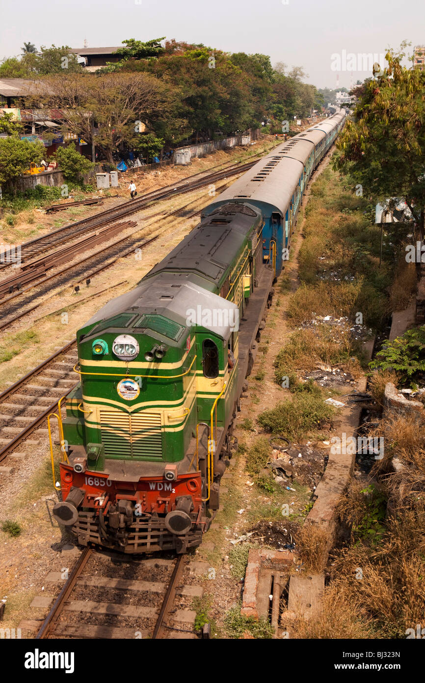 India, Kerala, Calicut, Kozhikode, diesel locomotive hauling passenger train into railway station, elevated view Stock Photo