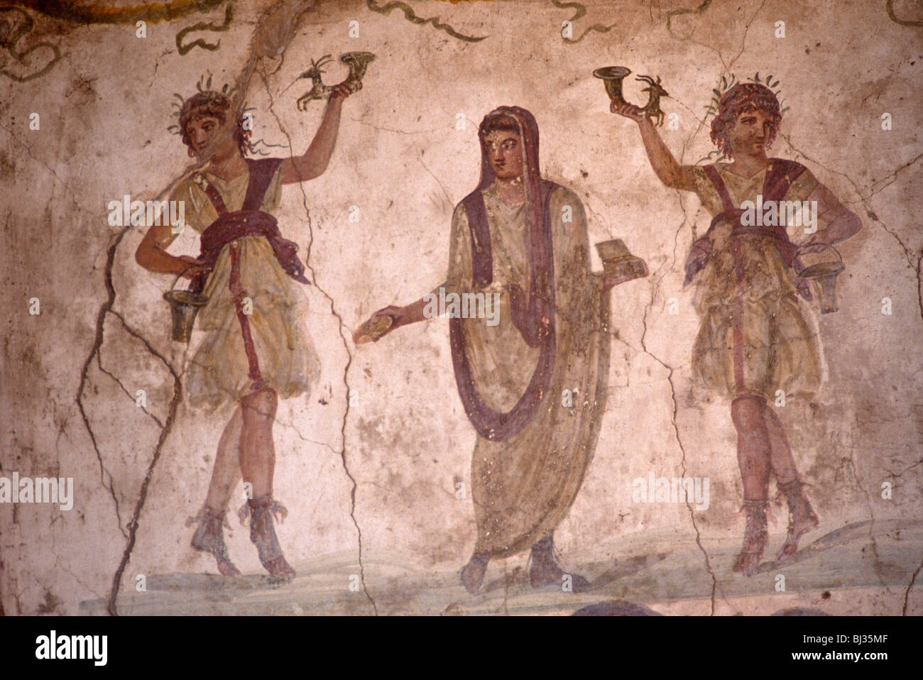 An ancient Roman fresco in the lararium, a shrine to Roman guardian spirits of a villa in the ruined town of Pompeii Stock Photo
