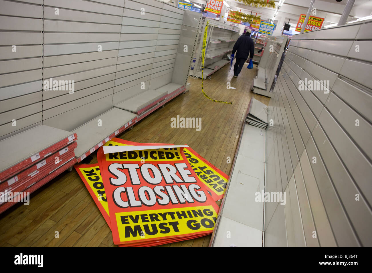 The last day of trading, surrounded by empty shelves and shop fittings