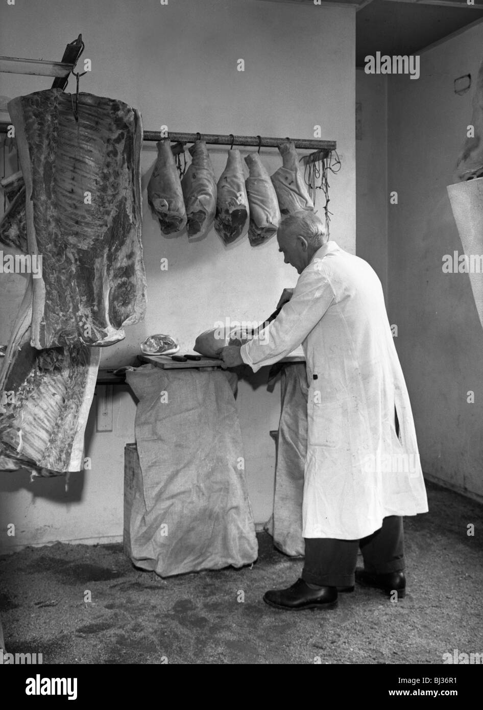 Dressing meat for sale, Rawmarsh, South Yorkshire, 1955. Artist: Michael Walters Stock Photo