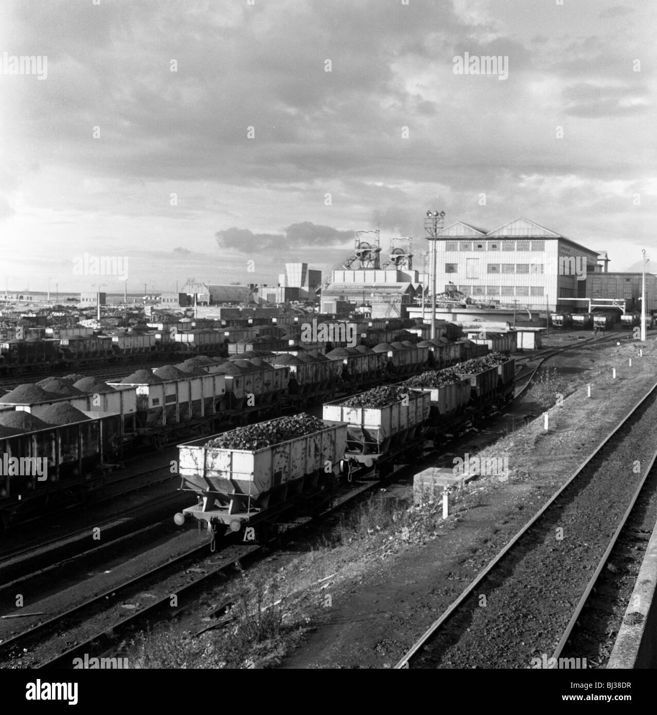 Rail trucks loaded with coal leaving Lynemouth Colliery, Northumberland, 1963.  Artist: Michael Walters Stock Photo
