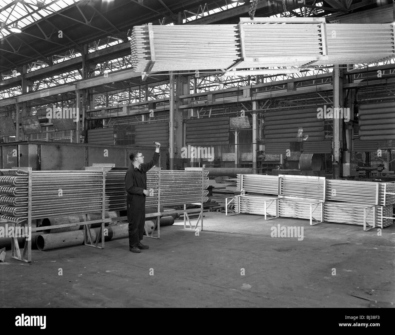 Lowering galvanised heat exchangers, Edgar Allen Steel Co, Sheffield, South Yorkshire, 1964. Artist: Michael Walters Stock Photo