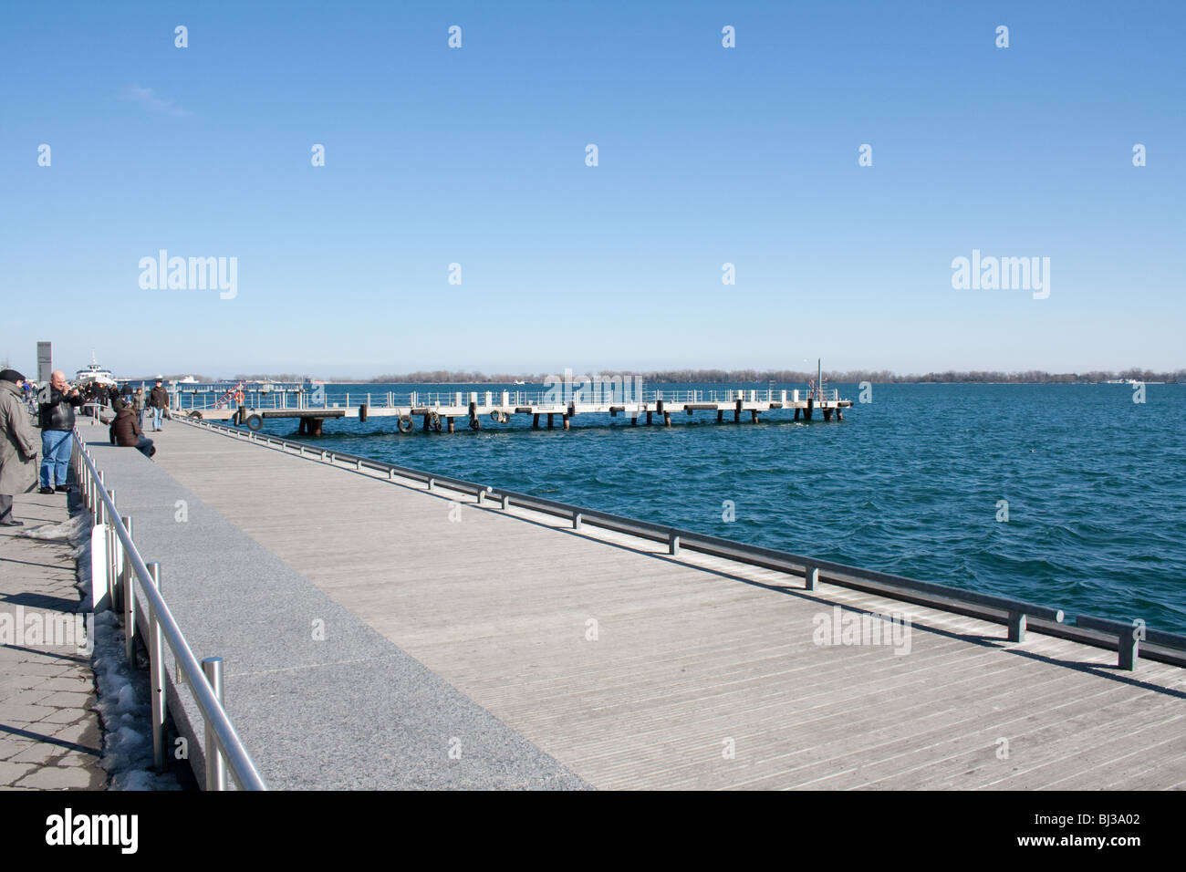 Walkway at the harborfront during a sunny winter afternoon Stock Photo
