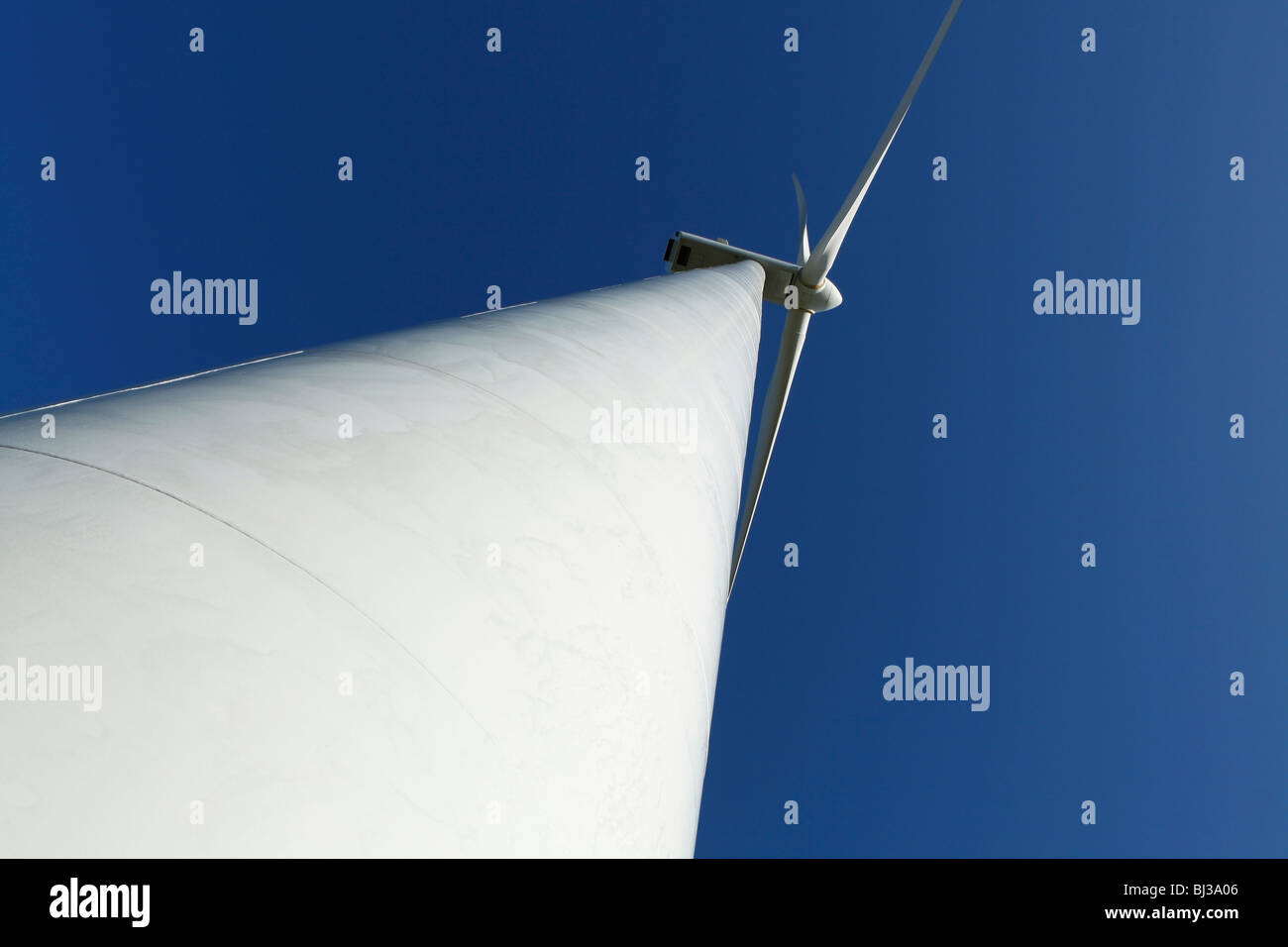 A wind turbine against a clear blue sky. Great for energy and environment themes. Stock Photo