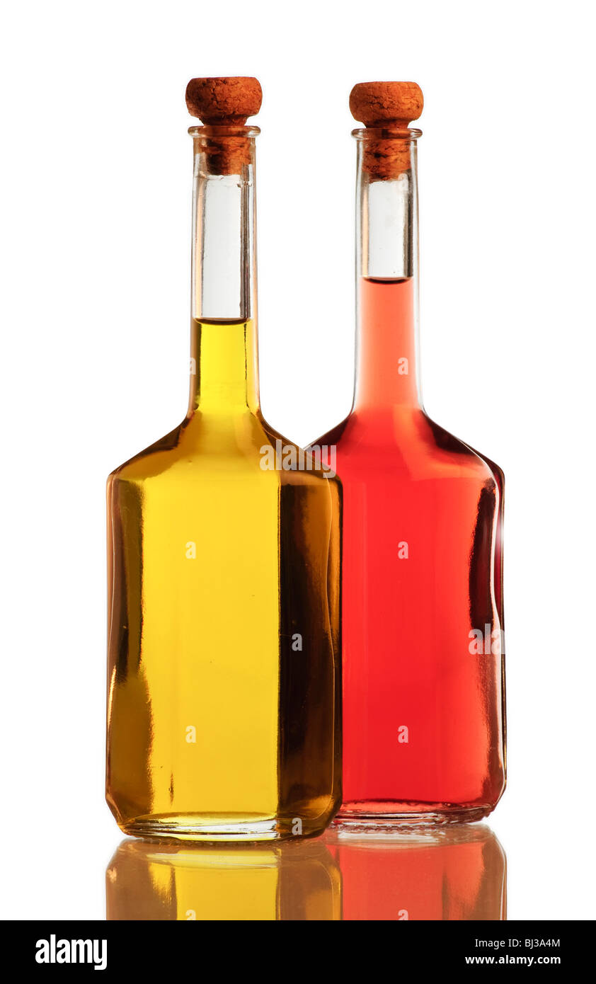 Bottles of golden olive oil and red vinegar isolated on white background Stock Photo