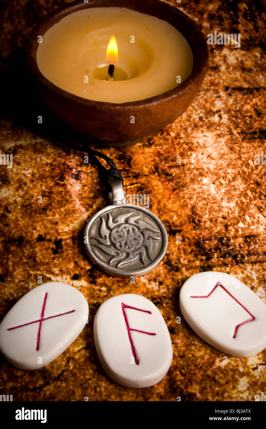 runes stones amulet and candle Stock Photo - Alamy