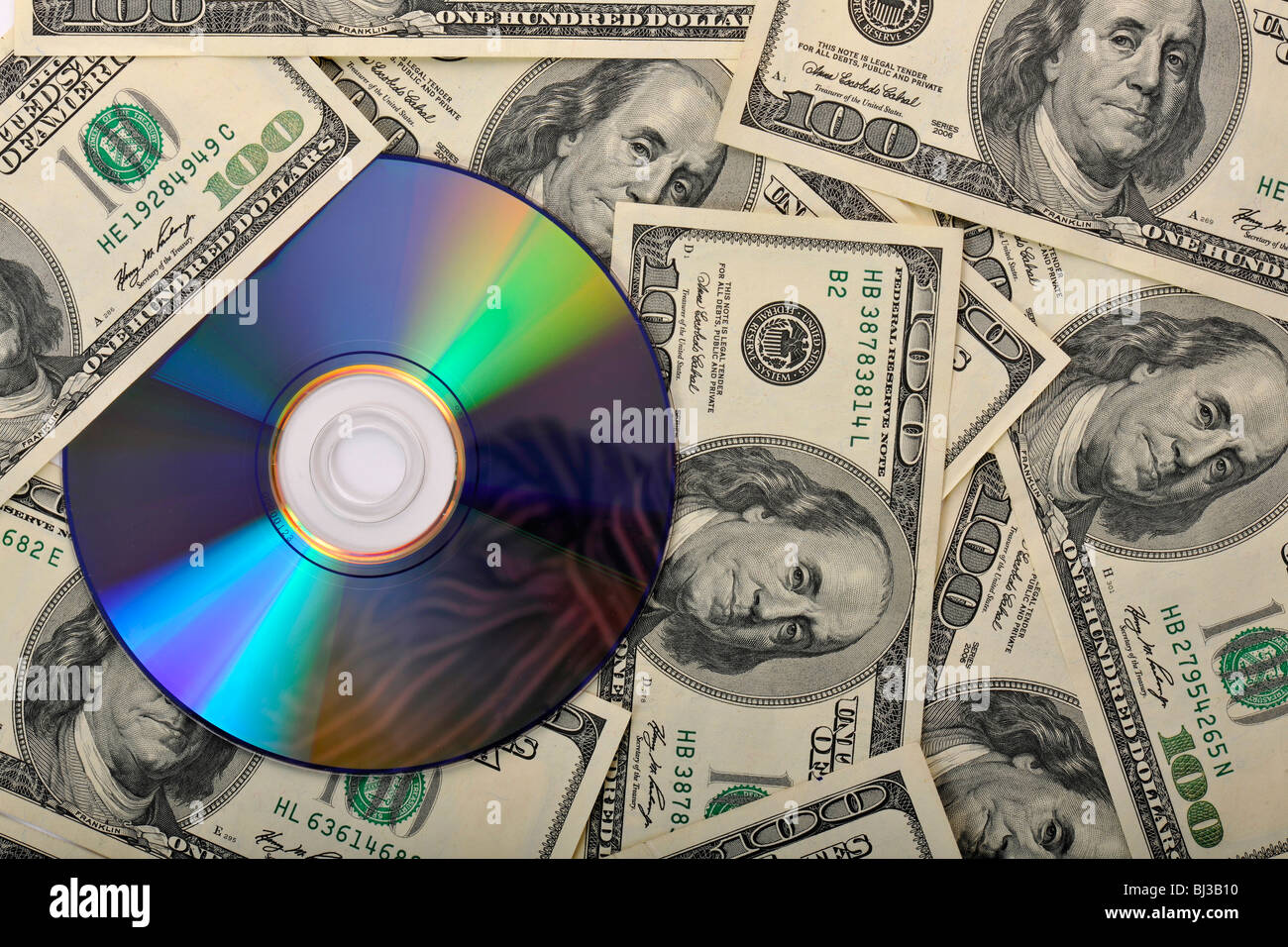 DVD, CD, 100-dollar bills, symbolic image for the purchase of bank records, tax evasion, privacy Stock Photo