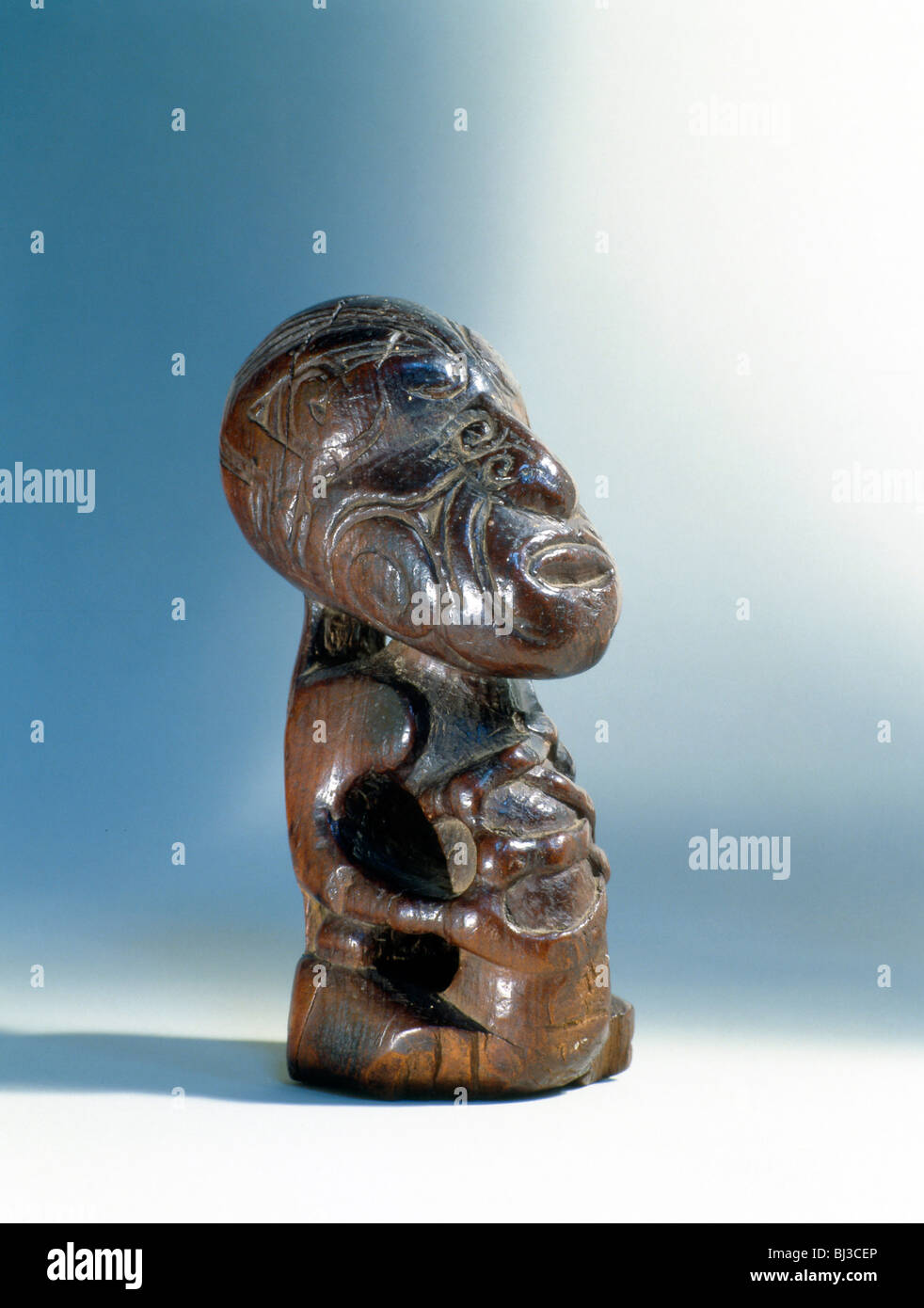 Small wooden seated Maori figure, New Zealand. Artist: Werner Forman Stock Photo