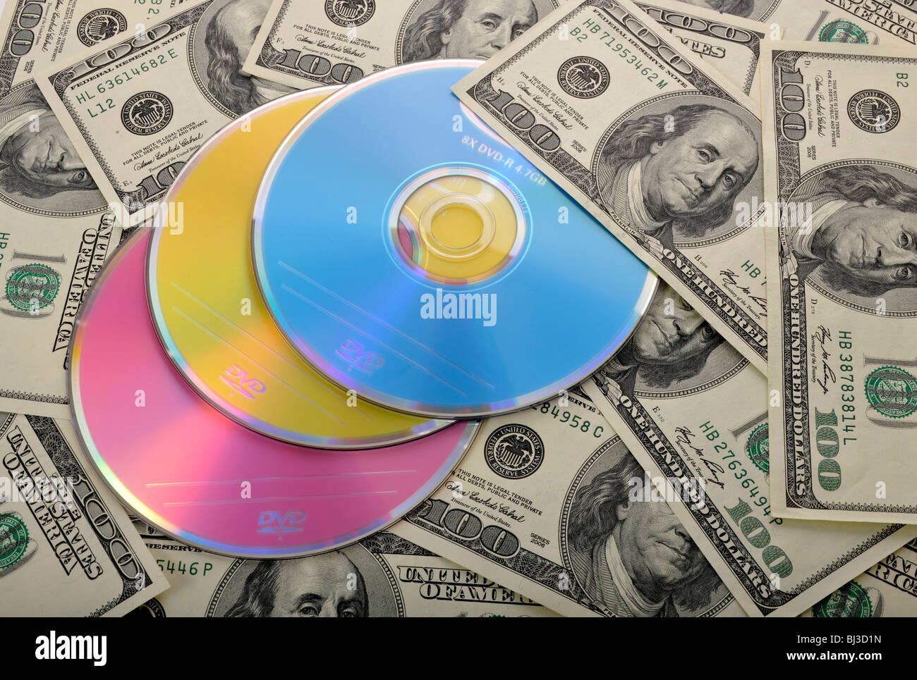 DVDs, CDs, 100-dollar bills, symbolic image for the purchase of bank records, tax evasion, privacy Stock Photo