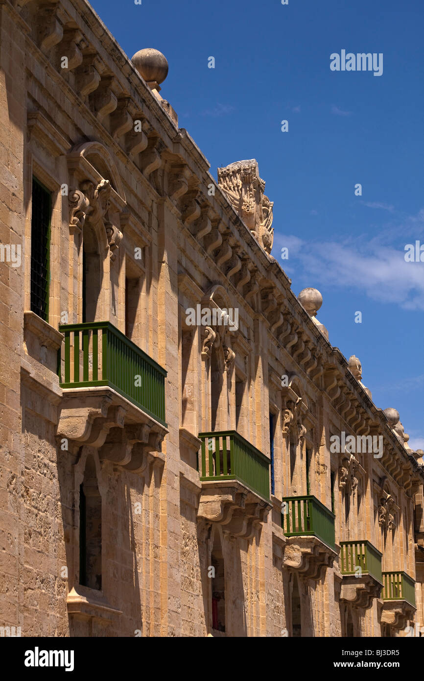 Green balconies overlooking a street in Valletta the capital of Malta Stock Photo