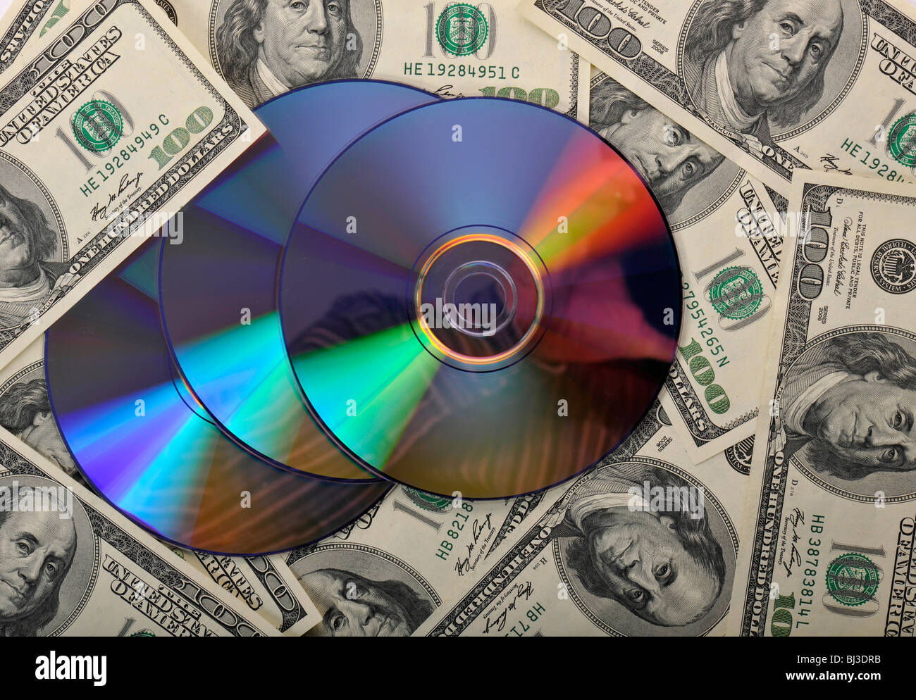 DVDs, CDs, 100-dollar bills, symbolic image for the purchase of bank records, tax evasion, privacy Stock Photo