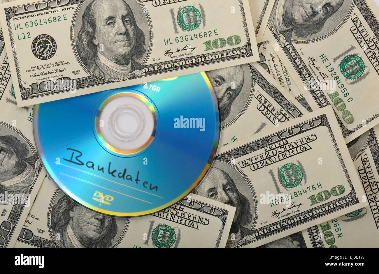 DVD, CD, 100-dollar bills, symbolic image for the purchase of bank records, tax evasion, privacy Stock Photo
