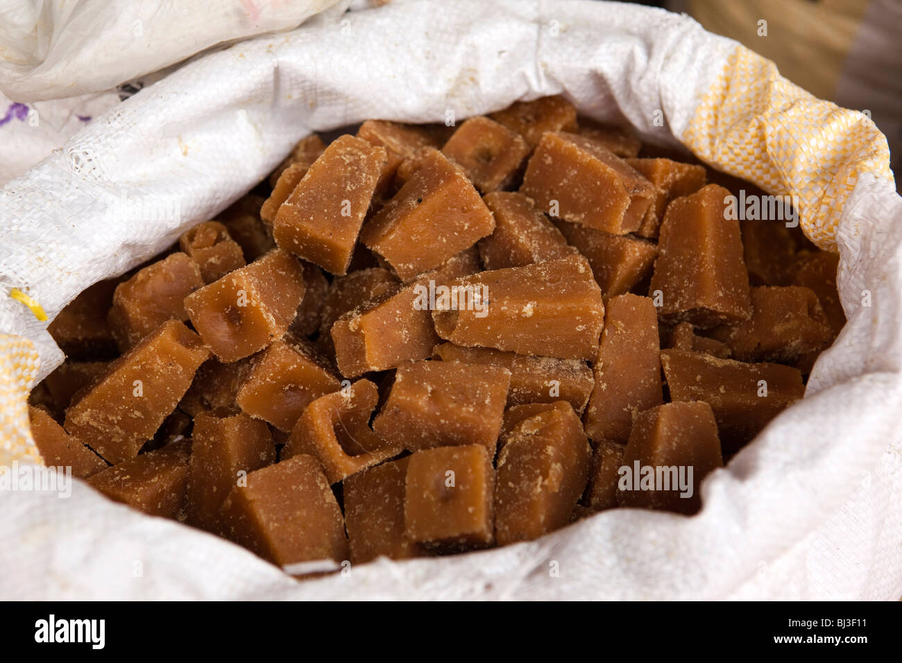 India, Kerala, Calicut, Kozhikode, Halwa Bazaar, sak of jaggery, raw unrefined sugar on display in food wholesaler Stock Photo