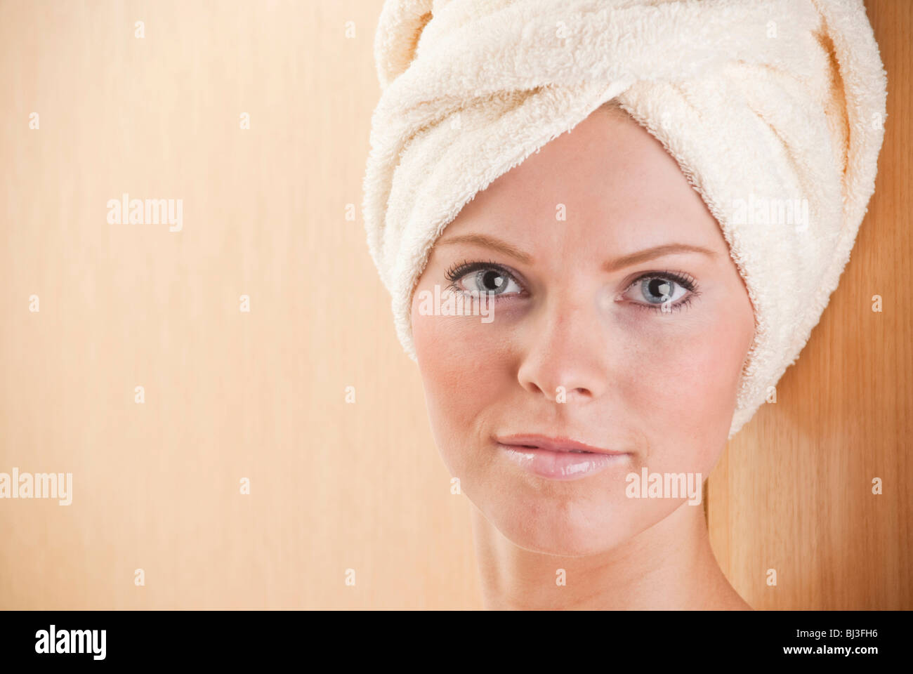 Young woman with a towel wrapped around her head Stock Photo