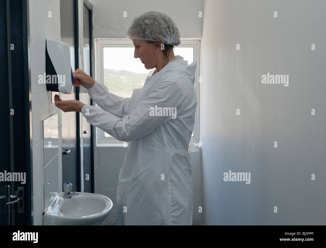 Factory worker using soap dispenser Stock Photo Alamy