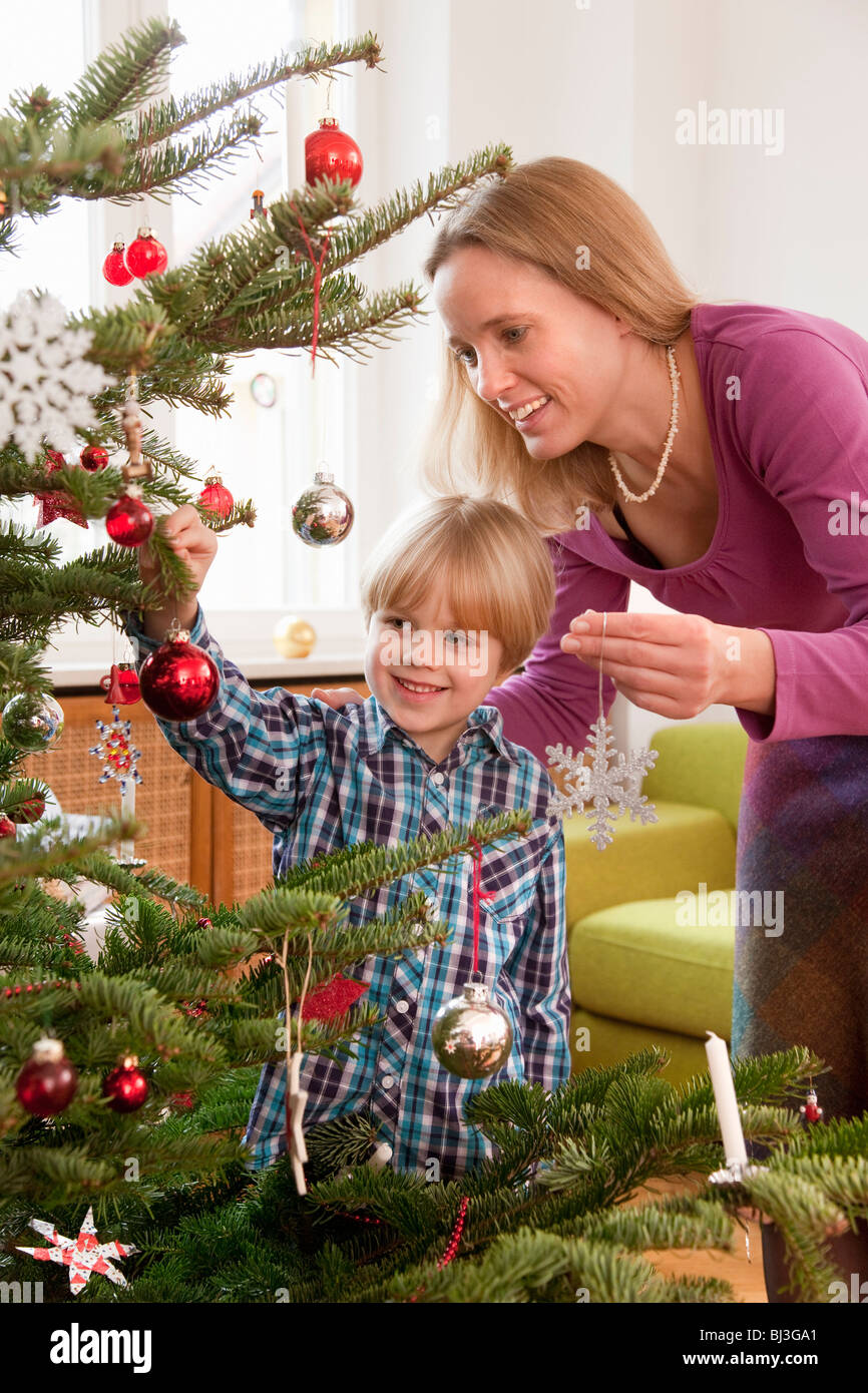 mother, son decorating christmas tree Stock Photo - Alamy