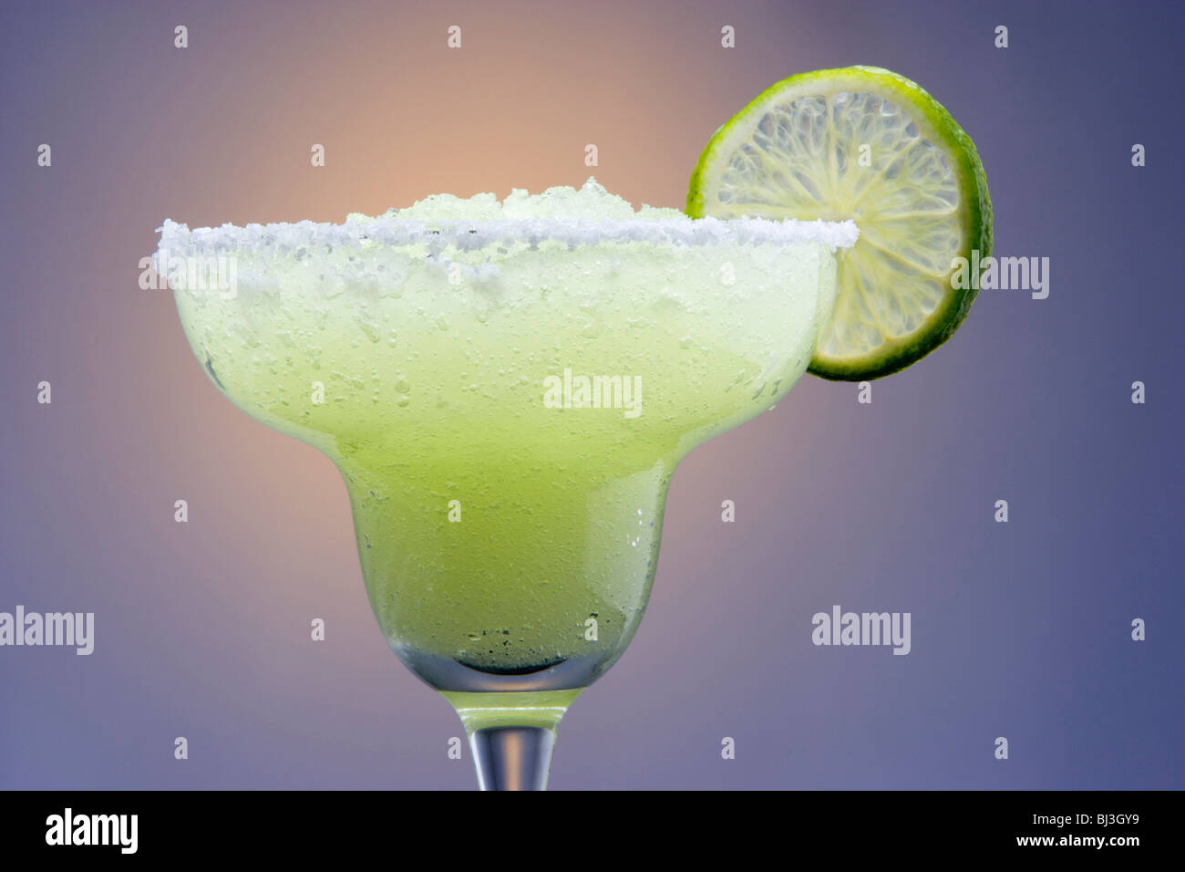 Frozen Margarita with Lime Garnish on Highlighted Background Stock