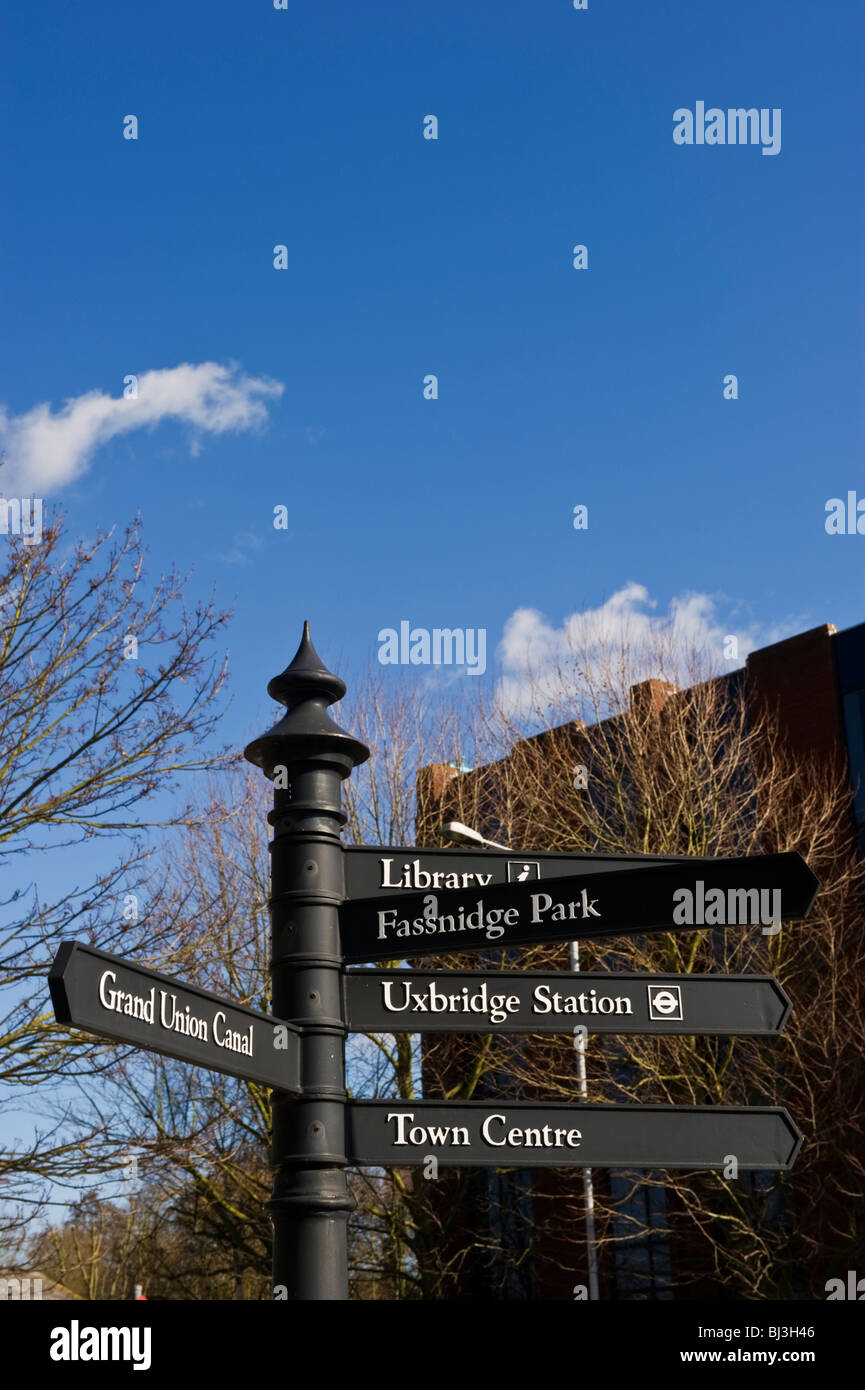 Signpost giving directions and a low emission zone sign in Uxbridge