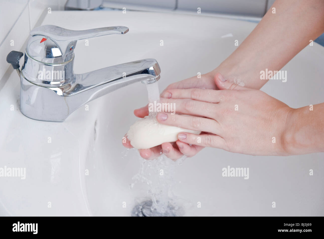 Women washing her hands with soap Stock Photo