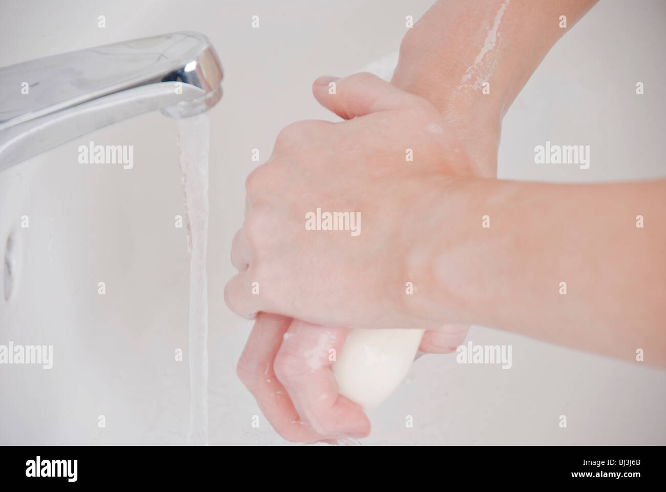Women washing her hands with soap Stock Photo