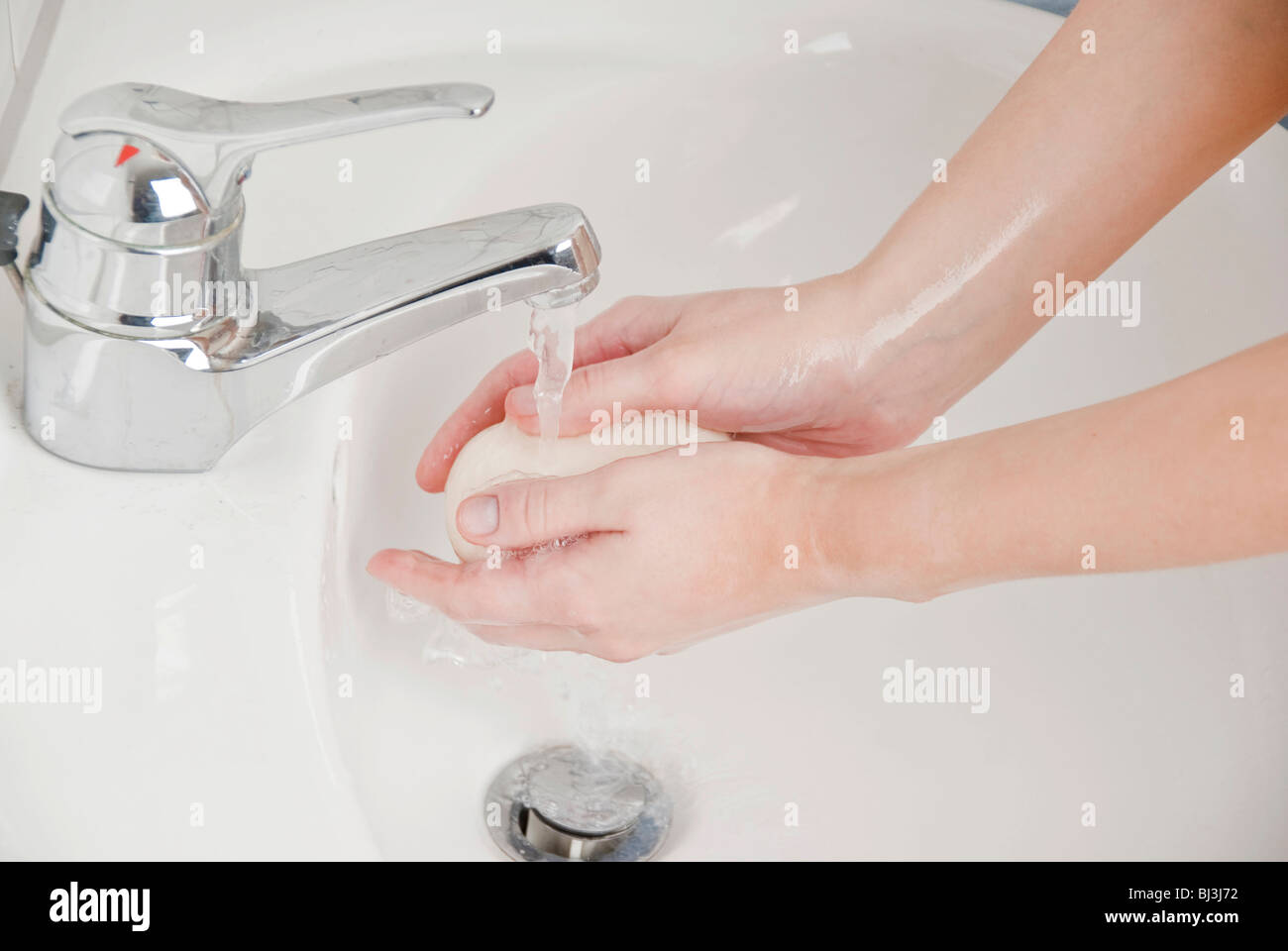 Women washing her hands with soap Stock Photo
