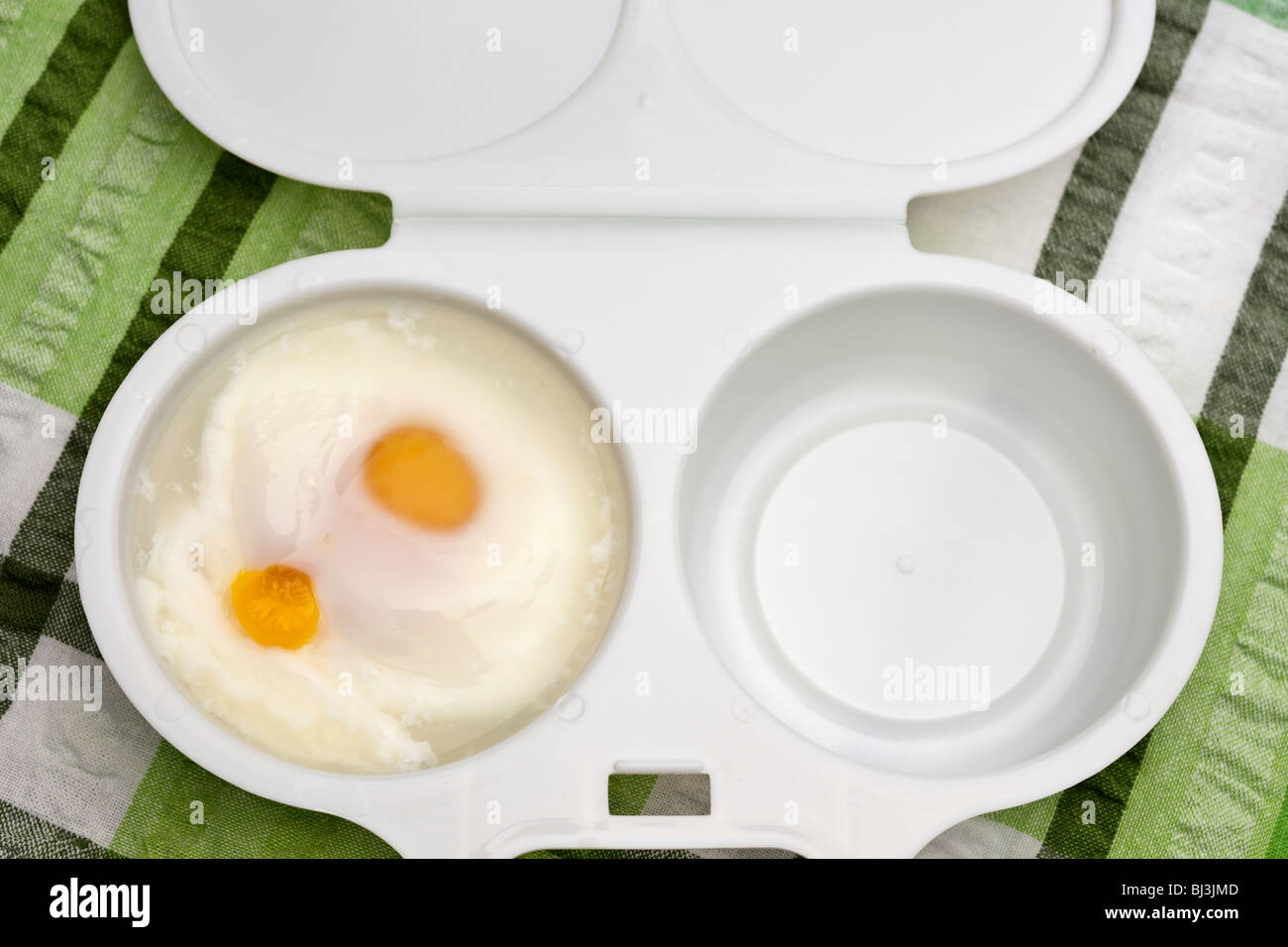 microwave two egg cooker with two cooked eggs Stock Photo - Alamy