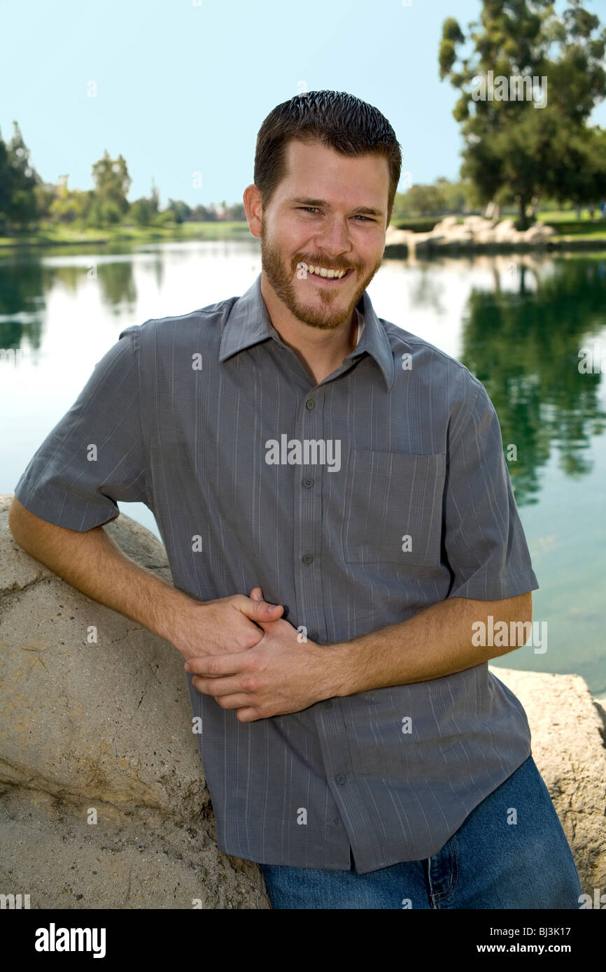 Portrait of 20 to 30 year old young man in park young person people nature, natural surroundings, relaxed relax relaxing MR  © Myrleen Pearson Stock Photo