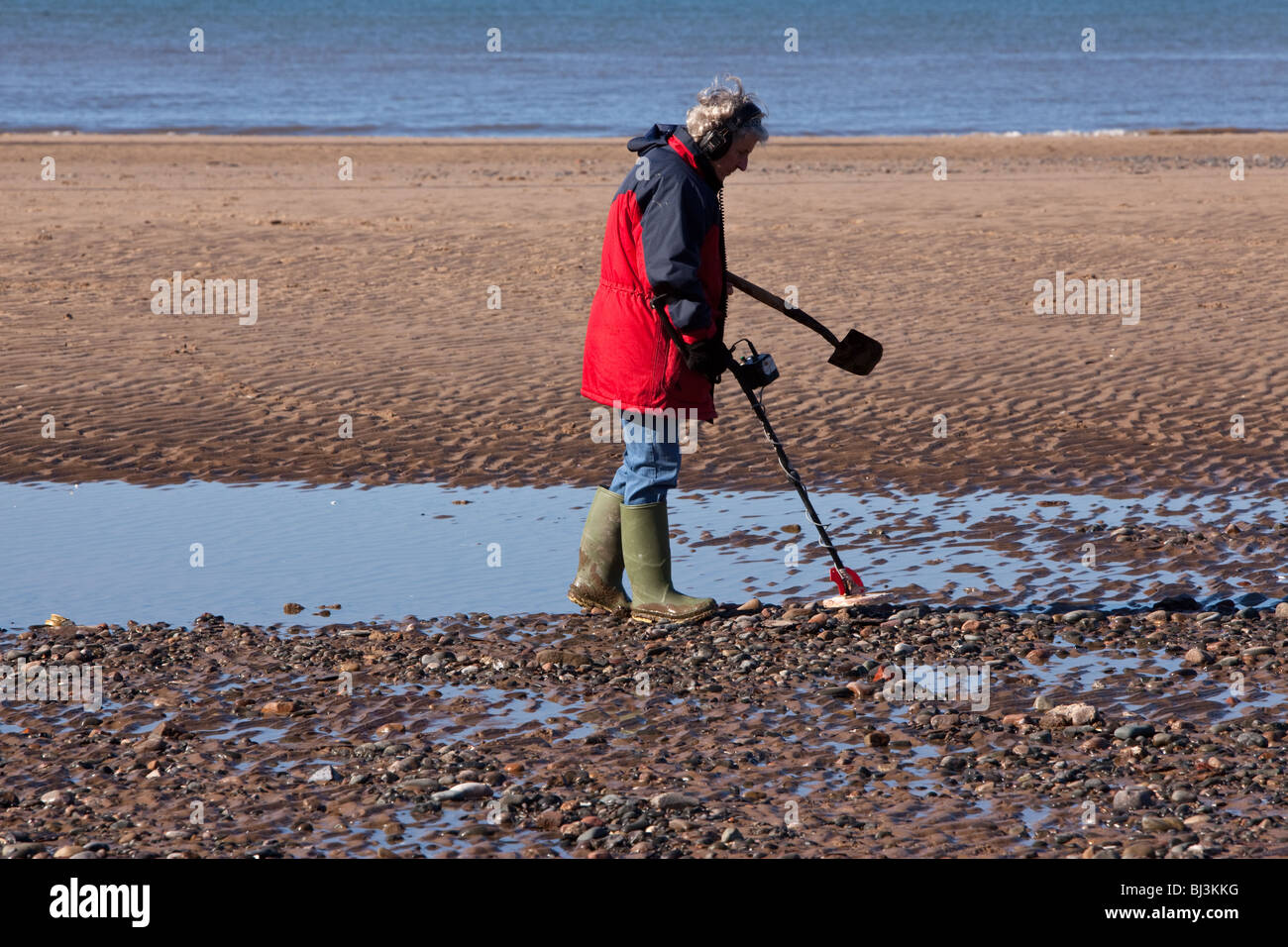 Modern treasure hunting with a metal detector on Blackpool beach Stock