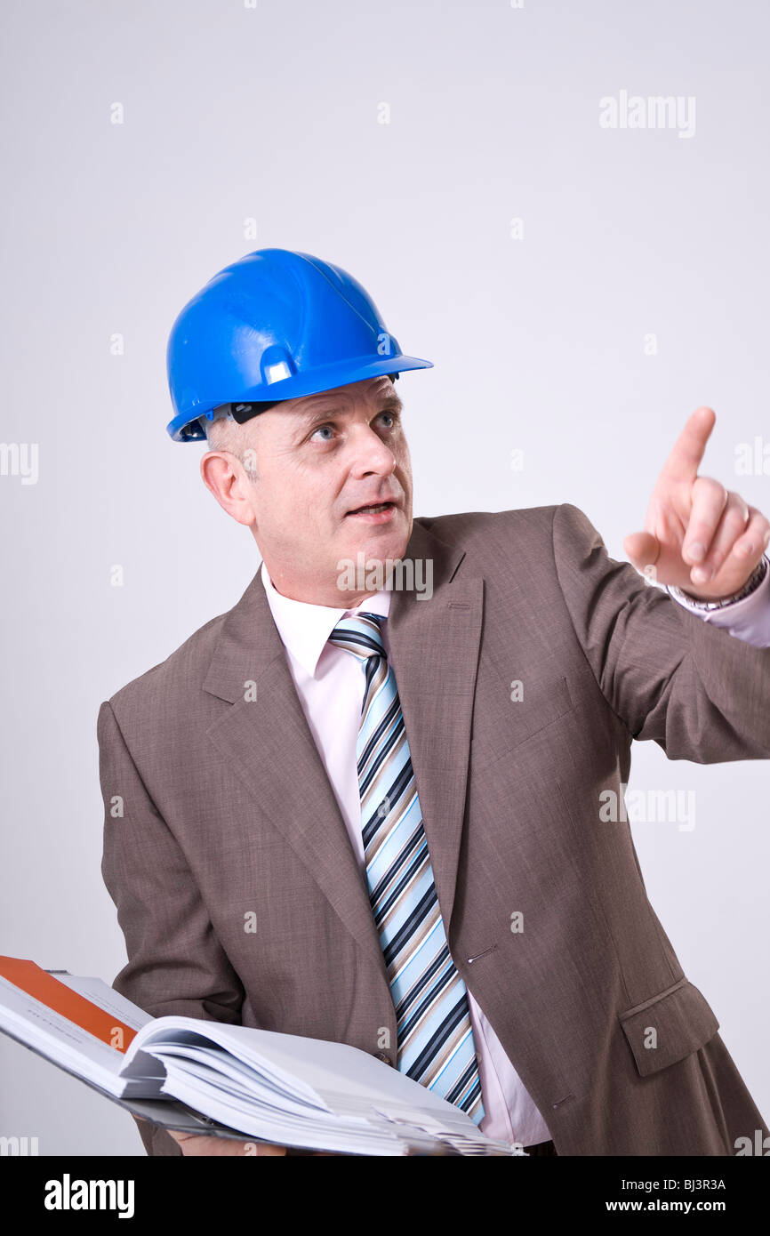 Man with hard hat and file pointing to one direction Stock Photo Alamy