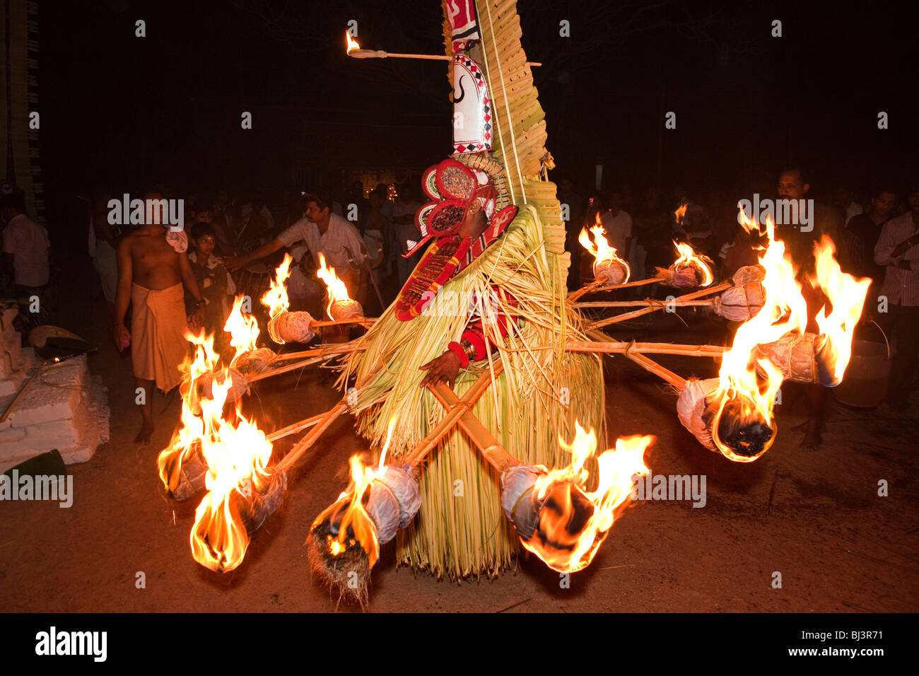 India, Kerala, Cannanore (Kannur), Theyyam, ancient folk art ritual, Agni-Ghandakaran dancing surrounded by flaming torches Stock Photo