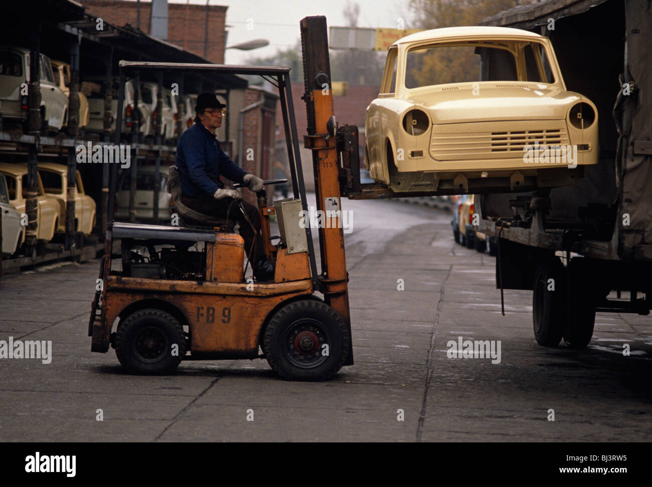 A new Trabant car shell is lifted by forklift from a truck at the East German auto maker VEB Sachsenring Automobilwerke Zwickau. Stock Photo