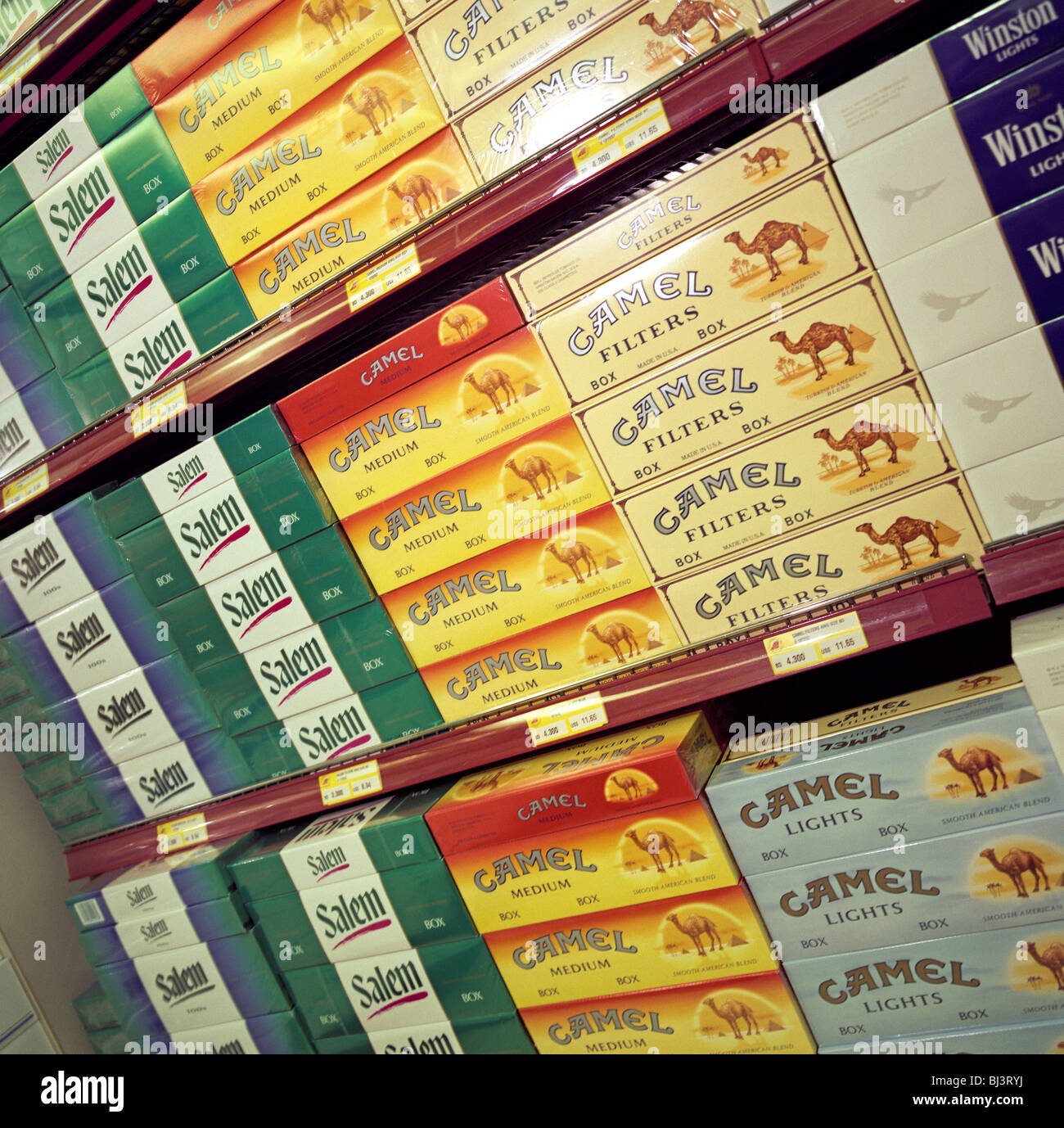 Stacks of cigarette cartons are piled up in a display of duty free goods at Bahrain International airport. Stock Photo