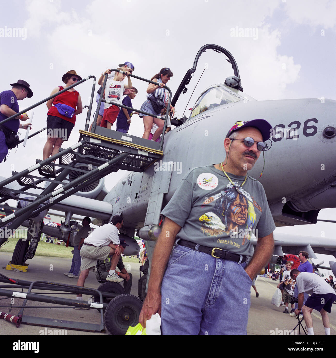 A visitor to Oshkosh Air Venture, the world’s largest air show in Wisconsin USA, stands by an A-10 Thunderbolt tank buster Stock Photo