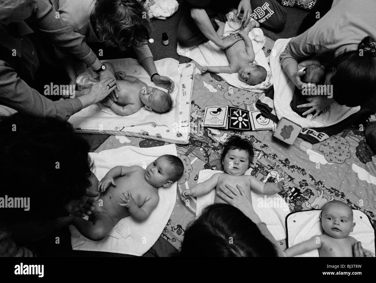A baby massage class takes place at a health clinic in south London. Stock Photo