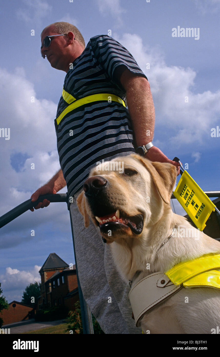 Wearing darkened glasses, unsighted Tim Gutteridge stands outside The Guide Dogs for the Blind Association's offices. Stock Photo