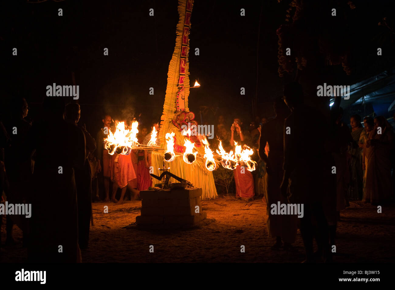 India, Kerala, Cannanore (Kannur), Theyyam, ancient folk art ritual, Agni-Ghandakaran dancing surrounded by flaming torches Stock Photo