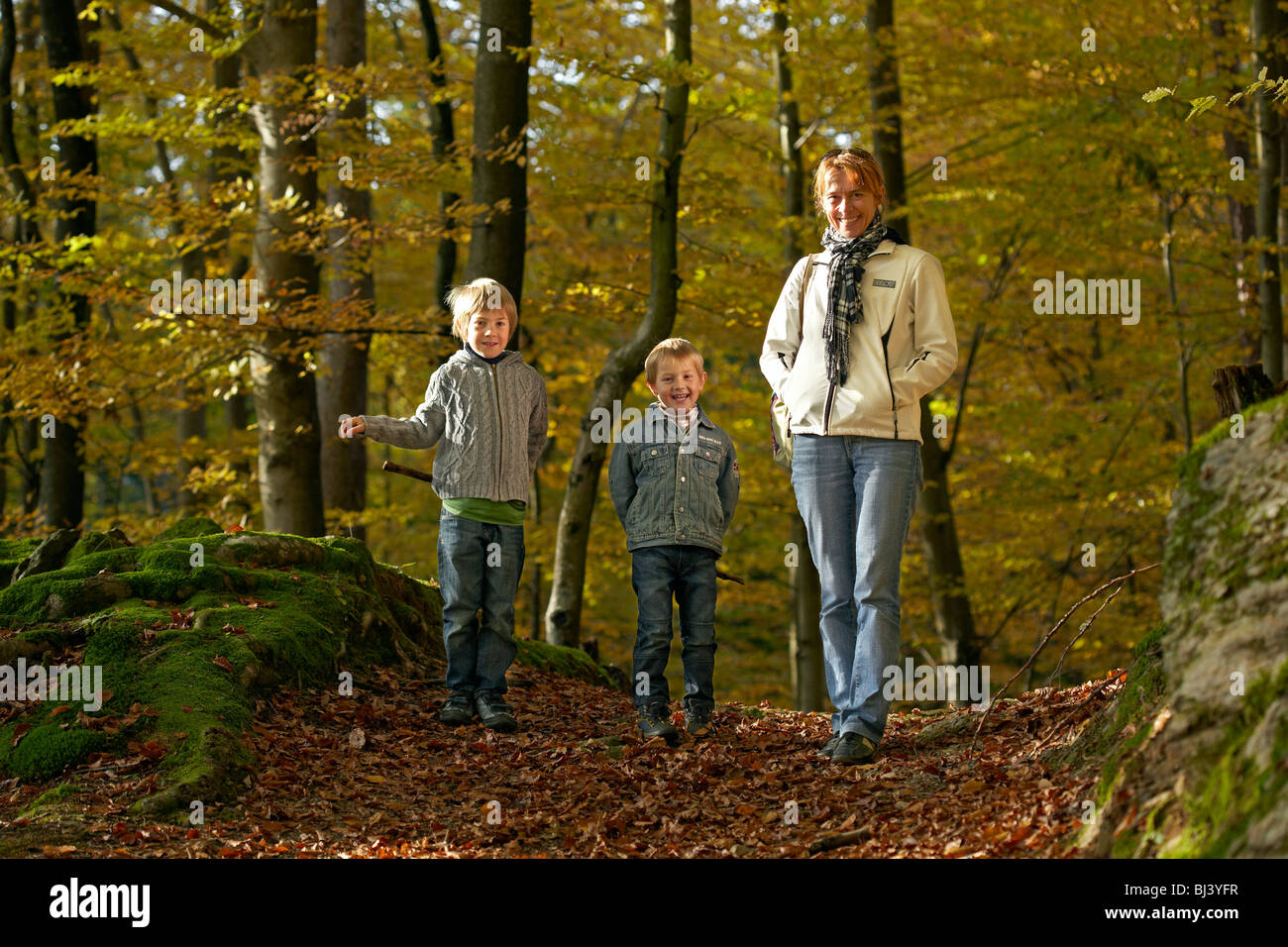 Woman with children in the forest, St. Margarethen, Reifnitz, Pyramidenkogel mountain, Carinthia, Austria, Europe Stock Photo