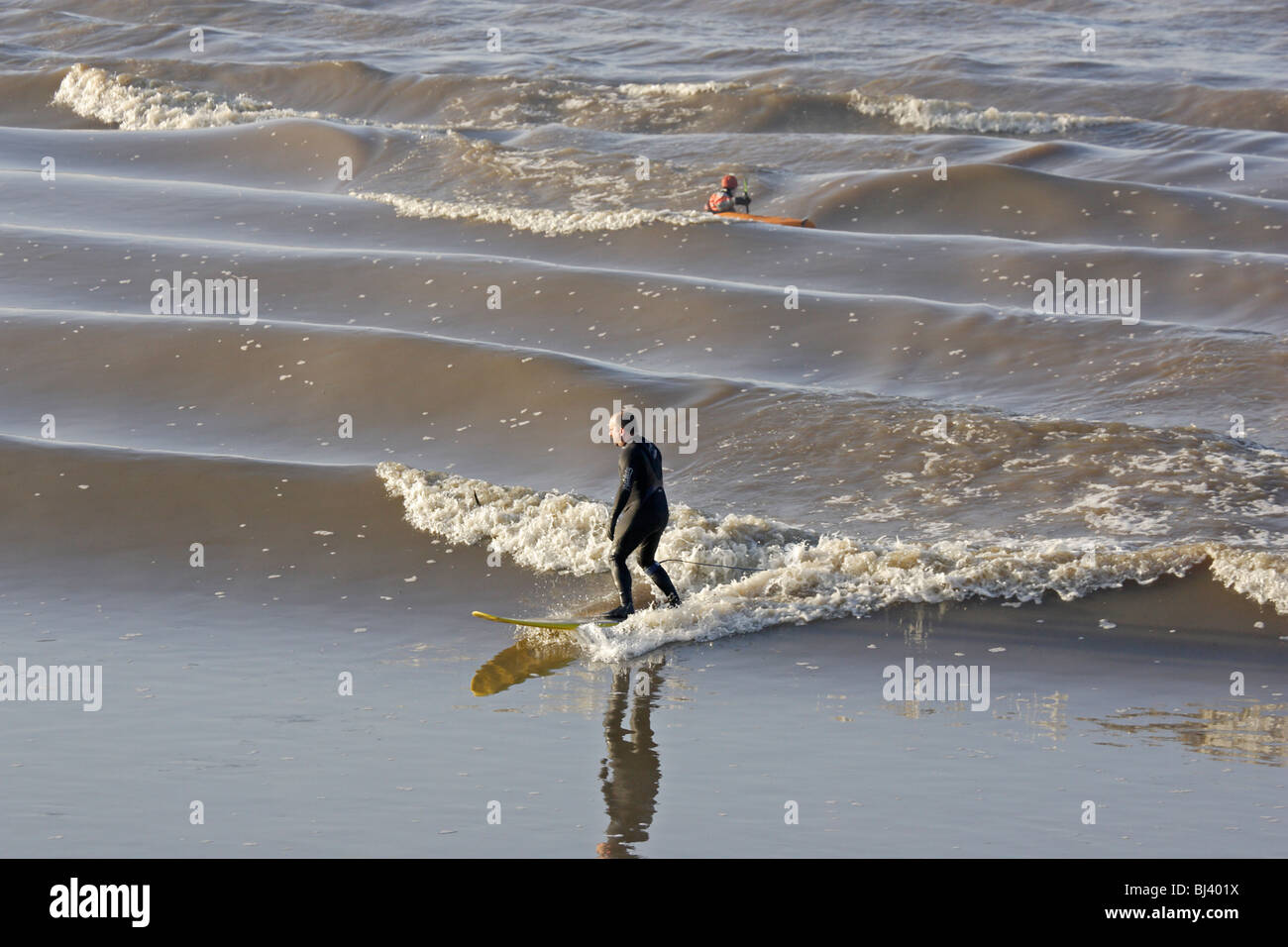 Surfer riding the Severn Bore at Newnham on Severn Stock Photo