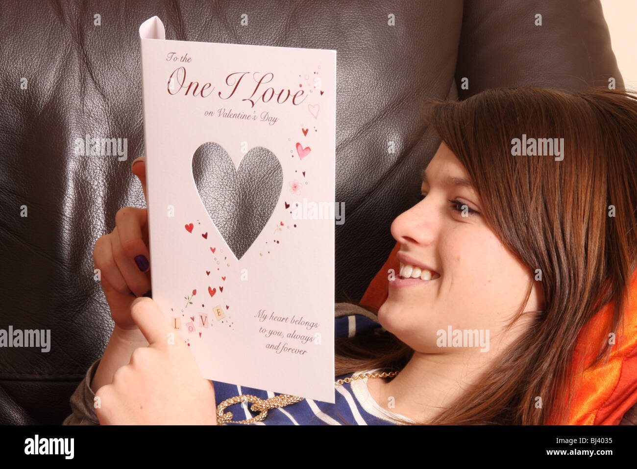 A young girl reading a Valentine card. Stock Photo